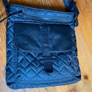 Pistil black crossbody bag with floral lining 1 interior & 3 exterior pockets.